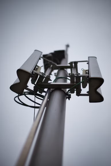 a phone base station tower against the gray sky