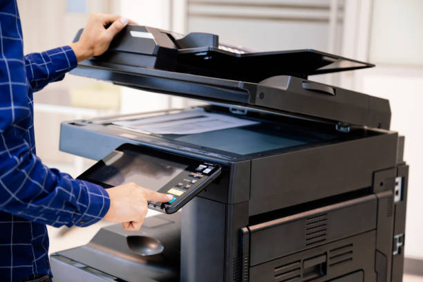 a man using an office printer