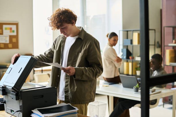 a man using a commercial office printer